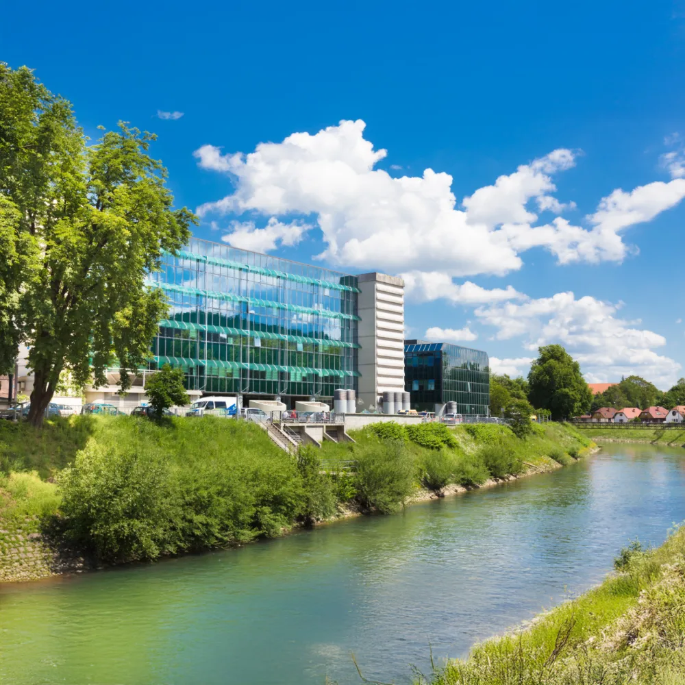 A modern hospital building beside a river